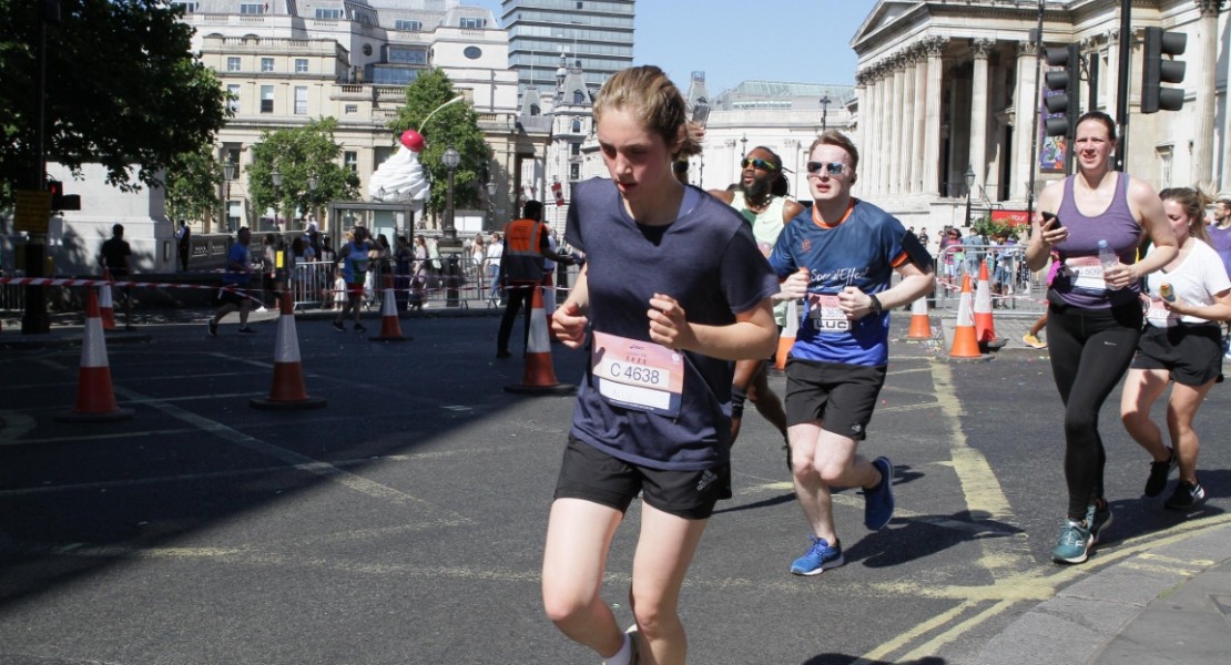 A picture of myself (Luc Shelton) between two other participants, running around the corner on the final stretch of the ASICS London 10K. I am wearing a SpecialEffect jersey.